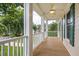Cozy front porch features white columns, railings and ceiling fan offering a relaxing outdoor space at 5205 Coffeetree Dr, Raleigh, NC 27613