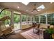 Bright sunroom with skylights, windows to exterior, and hanging chair at 5205 Coffeetree Dr, Raleigh, NC 27613