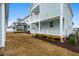 Spacious backyard shows landscaping, irrigation, grass beginning to grow, and a back porch at 524 Folk Song Way, Wendell, NC 27591