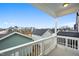 Enjoy neighborhood views from this covered balcony with white railings and classic columns at 524 Folk Song Way, Wendell, NC 27591