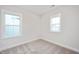 Bright bedroom featuring carpet, white trim, neutral paint and natural light from two windows at 524 Folk Song Way, Wendell, NC 27591