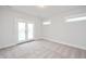 Bedroom with carpet, ample light, and access to a balcony through double doors at 524 Folk Song Way, Wendell, NC 27591