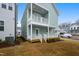 Two-story home with dual balconies overlooking the landscaped backyard at 524 Folk Song Way, Wendell, NC 27591