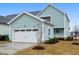 Charming home with a two-car garage, lush landscaping, and a welcoming front porch at 524 Folk Song Way, Wendell, NC 27591