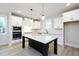 Bright kitchen with stainless appliances, granite countertops, an island and modern finishes at 524 Folk Song Way, Wendell, NC 27591