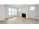 Bright and airy living room featuring a fireplace and light wood flooring at 524 Folk Song Way, Wendell, NC 27591