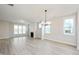 Spacious living room featuring light wood floors, large windows, and a fireplace at 524 Folk Song Way, Wendell, NC 27591