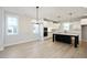 Open-concept area with kitchen island and white cabinetry in background at 524 Folk Song Way, Wendell, NC 27591