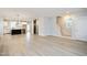 Open-concept living space featuring light wood floors, kitchen and staircase at 524 Folk Song Way, Wendell, NC 27591