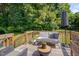 Relaxing back deck featuring outdoor seating, a wooded view and quaint string lights at 5308 Bentgrass Dr, Raleigh, NC 27610