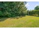 Sprawling backyard, lush green lawn, and mature trees, perfect for outdoor enjoyment at 5308 Bentgrass Dr, Raleigh, NC 27610