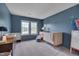 Cozy Bedroom featuring blue walls, carpet, and comfortable seating at 5308 Bentgrass Dr, Raleigh, NC 27610