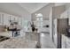 Bright kitchen with white cabinets, an island, stainless appliances, and hardwood floors at 5308 Bentgrass Dr, Raleigh, NC 27610