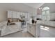 Spacious kitchen featuring white cabinets, granite countertops, island and stainless steel appliances at 5308 Bentgrass Dr, Raleigh, NC 27610