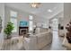 Bright living room with vaulted ceilings, fireplace, large windows, and open concept kitchen at 5308 Bentgrass Dr, Raleigh, NC 27610
