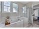 Well-lit bathroom with a soaking tub, glass shower, and tile flooring at 5308 Bentgrass Dr, Raleigh, NC 27610