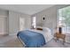 Comfortable main bedroom featuring a plush bed, carpeted floor, and soothing natural light at 5308 Bentgrass Dr, Raleigh, NC 27610