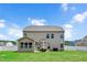 Two-story home featuring large backyard, a patio with seating, and well-maintained lawn at 5637 Garnet Meadow Rd, Knightdale, NC 27545