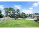 Expansive backyard with lush green grass, a playset, a shed, and mature trees at 5637 Garnet Meadow Rd, Knightdale, NC 27545