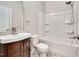 Bathroom showcases a vanity with sink, a toilet, and a bathtub with a shower head at 5637 Garnet Meadow Rd, Knightdale, NC 27545