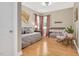 Bedroom featuring a crib, daybed, decor and hardwood floors, creating a cozy and inviting space at 5637 Garnet Meadow Rd, Knightdale, NC 27545