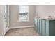 Cozy room with a window, storage cabinet, and plush carpet at 5637 Garnet Meadow Rd, Knightdale, NC 27545