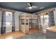 Bedroom featuring a bunk bed with an integrated desk, hardwood floors, and large windows at 5637 Garnet Meadow Rd, Knightdale, NC 27545