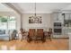 The dining room features a wooden table, chair seating, and a stylish chandelier, complementing the warm hardwood floors at 5637 Garnet Meadow Rd, Knightdale, NC 27545