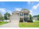 Charming two-story home with a front-facing garage, basketball hoop, and a welcoming balcony above the porch at 5637 Garnet Meadow Rd, Knightdale, NC 27545