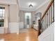 Spacious foyer with hardwood floors, a staircase, and a decorative bench, creating a welcoming entrance at 5637 Garnet Meadow Rd, Knightdale, NC 27545
