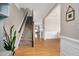 Bright foyer with hardwood floors, staircase, and stylish wainscoting leading into other rooms at 5637 Garnet Meadow Rd, Knightdale, NC 27545