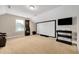 Spacious game room with plush carpet and a large screen for entertainment at 5637 Garnet Meadow Rd, Knightdale, NC 27545
