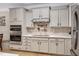 Contemporary kitchen featuring stainless steel appliances, white cabinets, and tile backsplash at 5637 Garnet Meadow Rd, Knightdale, NC 27545