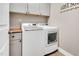 Bright laundry room features modern white washer and dryer, cabinetry, and countertop at 5637 Garnet Meadow Rd, Knightdale, NC 27545