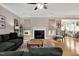 Comfortable living room with hardwood floors, a fireplace, a large sofa, and plenty of natural light at 5637 Garnet Meadow Rd, Knightdale, NC 27545
