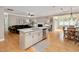 Open-concept kitchen and living room with hardwood floors, a kitchen island and a fireplace at 5637 Garnet Meadow Rd, Knightdale, NC 27545