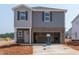 New two-story home features gray siding, brick accents, and an attached two-car garage at 648 Red River Dr, Garner, NC 27529