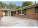 Backyard with a brick wall and large deck at 658 Hiawatha Pl, Burlington, NC 27217