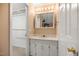 Bathroom vanity with white cabinets and closet off to the side at 658 Hiawatha Pl, Burlington, NC 27217
