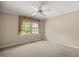 Bedroom featuring a ceiling fan, carpet, and a window with curtains at 658 Hiawatha Pl, Burlington, NC 27217