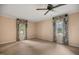 Spacious bedroom with fan, two windows, and light-peach colored walls at 658 Hiawatha Pl, Burlington, NC 27217