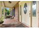 Inviting front porch with brick flooring, decorative front door, and space for relaxing seating at 658 Hiawatha Pl, Burlington, NC 27217