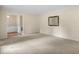 Comfortable living room with neutral carpet, featuring a mirror accent and doorway to an adjacent room at 658 Hiawatha Pl, Burlington, NC 27217