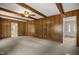 Living room featuring wood paneling and doorway to the kitchen at 658 Hiawatha Pl, Burlington, NC 27217