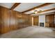 Living room featuring wood paneling, built-in bookshelves and a fireplace at 658 Hiawatha Pl, Burlington, NC 27217