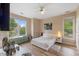 Bright bedroom with wood floors, ceiling fan, and two large windows offering ample natural light at 800 Savannah Ridge Rd # 109, Holly Springs, NC 27540