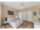 Cozy bedroom features wood floors, ceiling fan, and a spacious closet for ample storage at 800 Savannah Ridge Rd # 109, Holly Springs, NC 27540