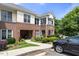 Charming townhouse exterior with brick accents, well-maintained landscaping, and convenient parking at 800 Savannah Ridge Rd # 109, Holly Springs, NC 27540