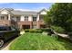 Well-kept townhouse exterior with brick facade, lush lawn, and convenient parking space, close to greenery at 800 Savannah Ridge Rd # 109, Holly Springs, NC 27540
