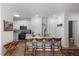 Bright kitchen features a center island with barstool seating and modern appliances at 800 Savannah Ridge Rd # 109, Holly Springs, NC 27540